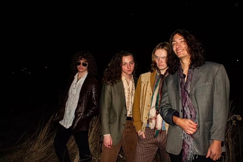 four bandmates pose for a picture