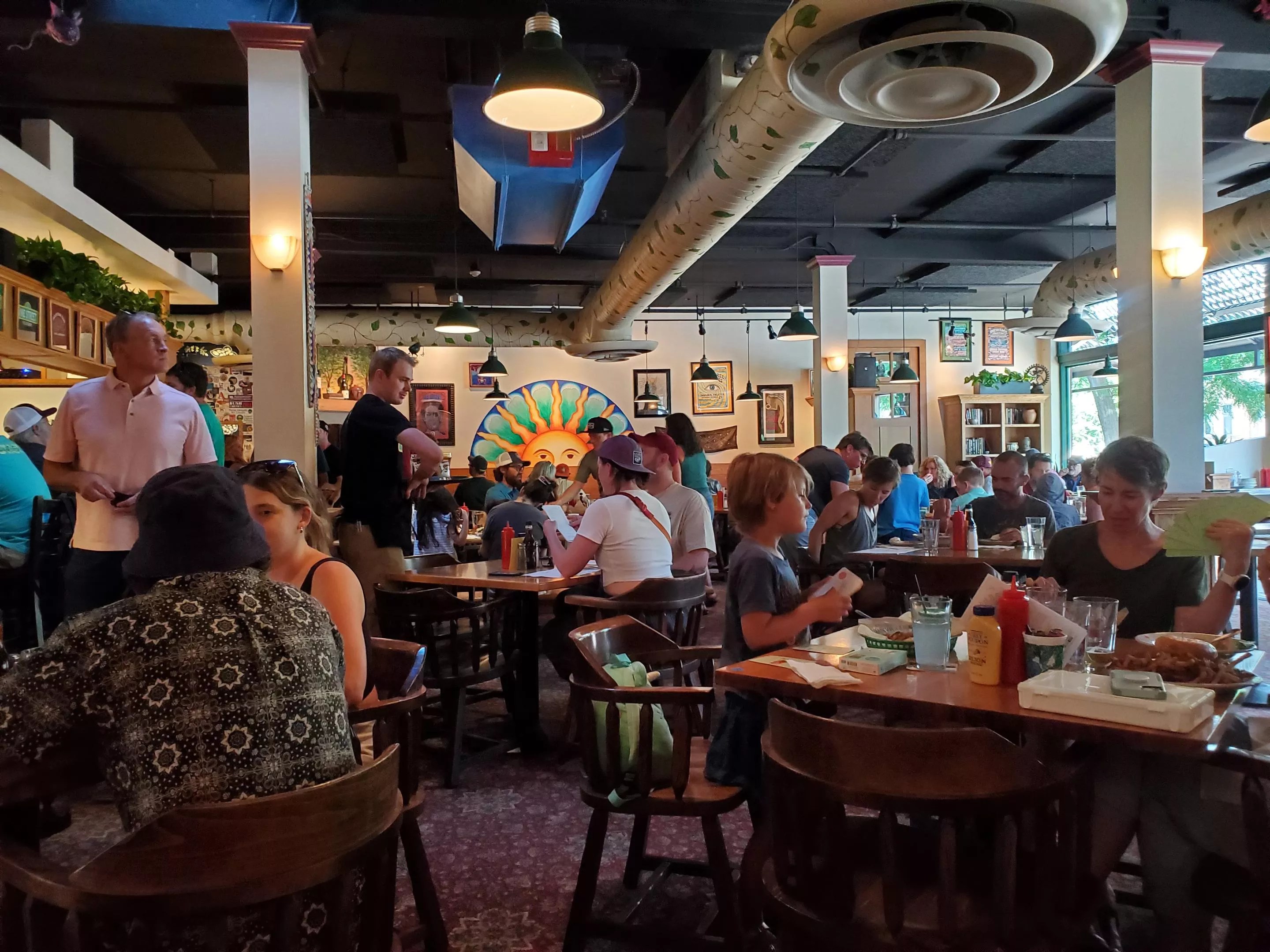 people sitting at tables inside a restaurant