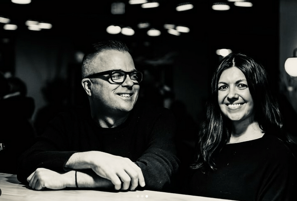 black and white photo of a man in glasses and a woman