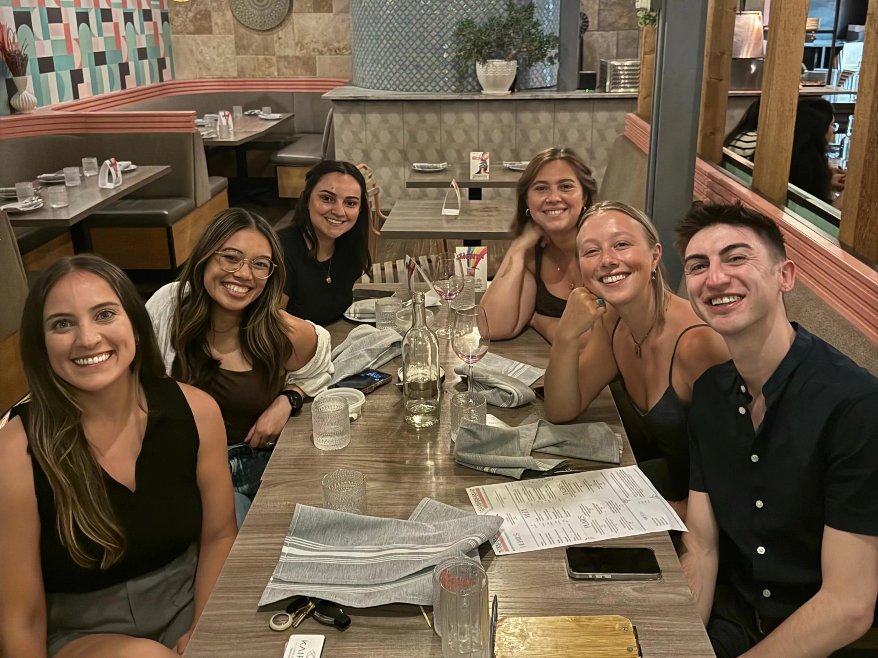 six people at a table in a restaurant