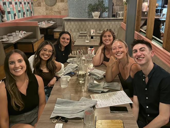 six people at a table in a restaurant