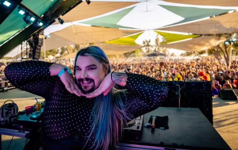 man smiling with hands under their chin