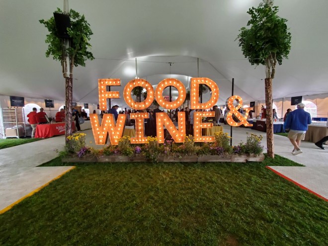large lit up letters that say "food & wine"
