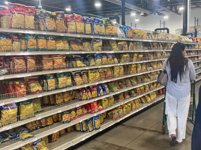 grocery aisle stocked with bags of snacks