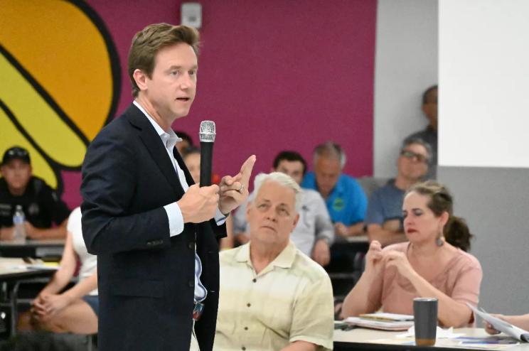 A person speaks to a crowd.