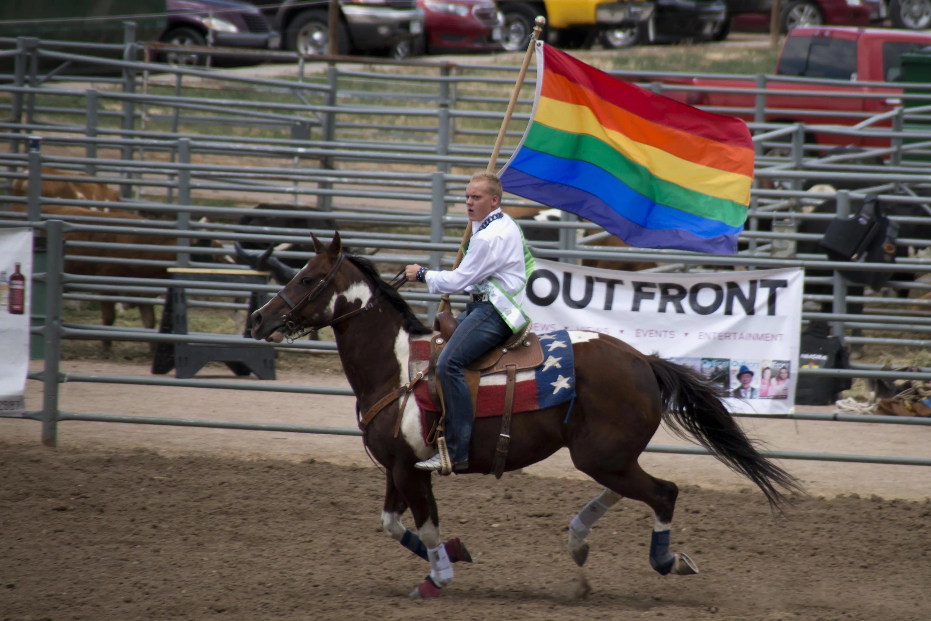 rodeo rider with gay flag