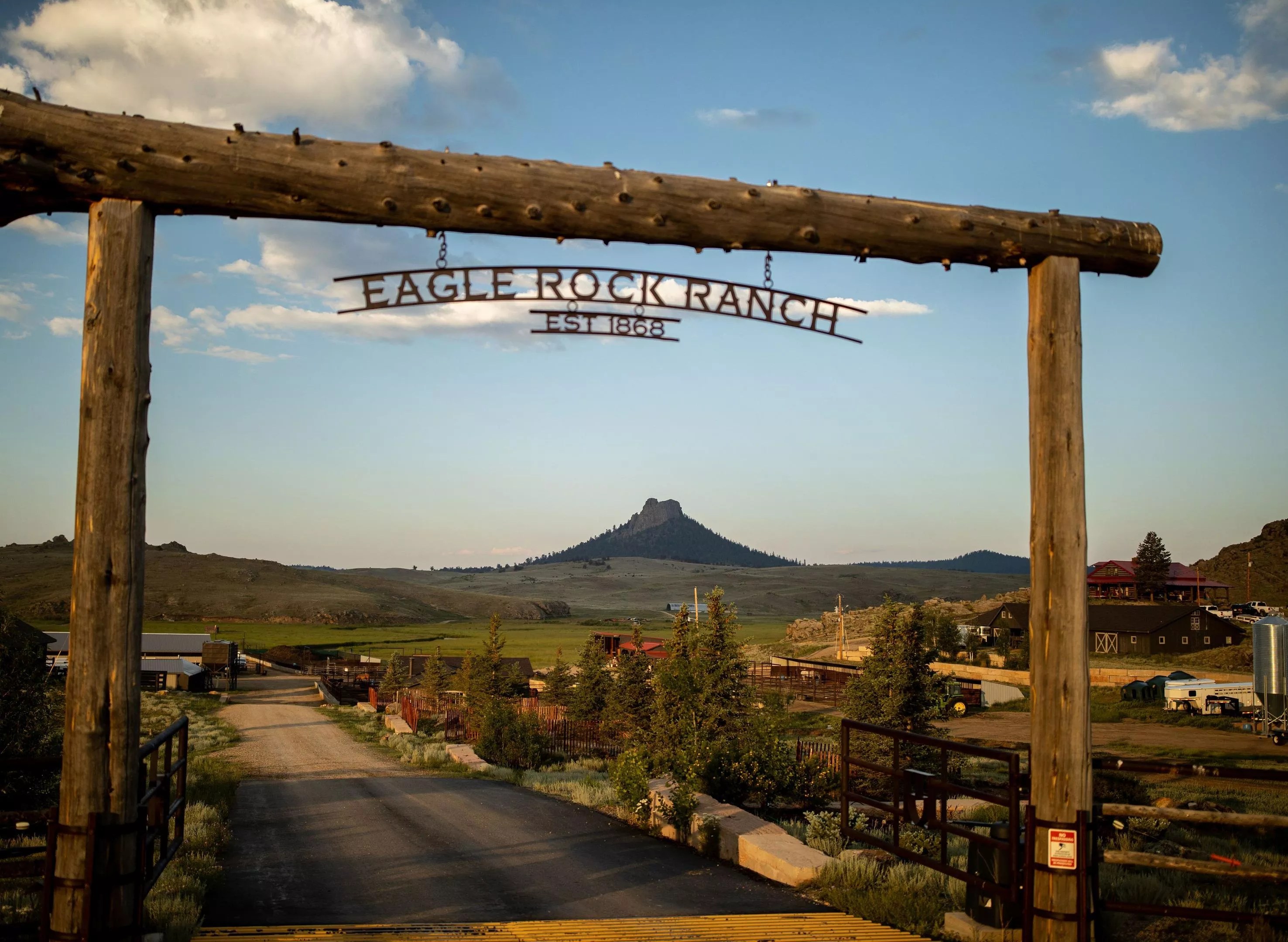 wooden ranch entrance in front of a mountain view
