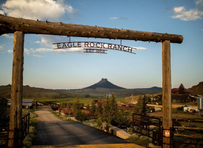wooden ranch entrance in front of a mountain view