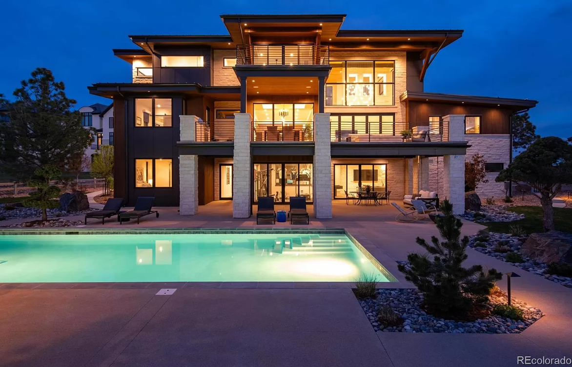 Colorado mcmansion at night with pool