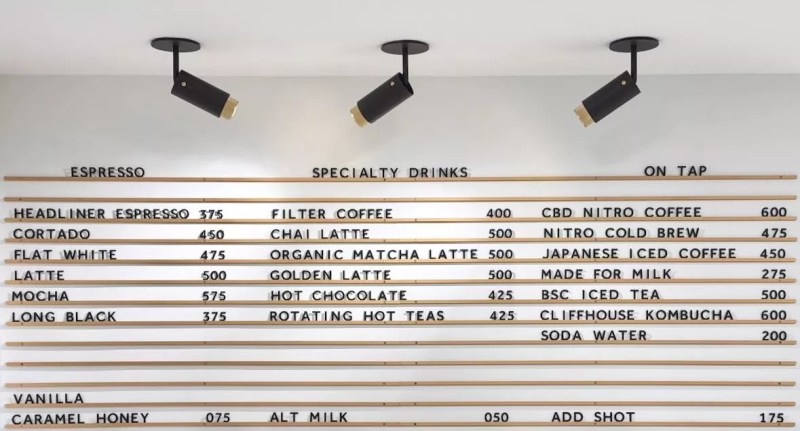 a white menu board with black letters