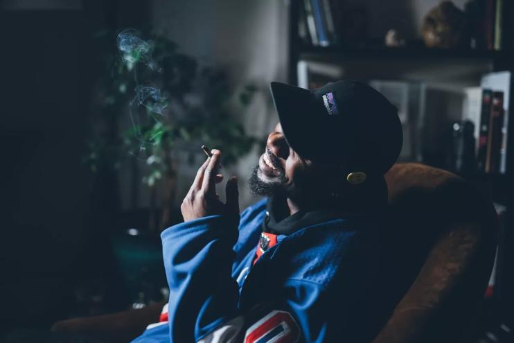 Man smokes joint in his home