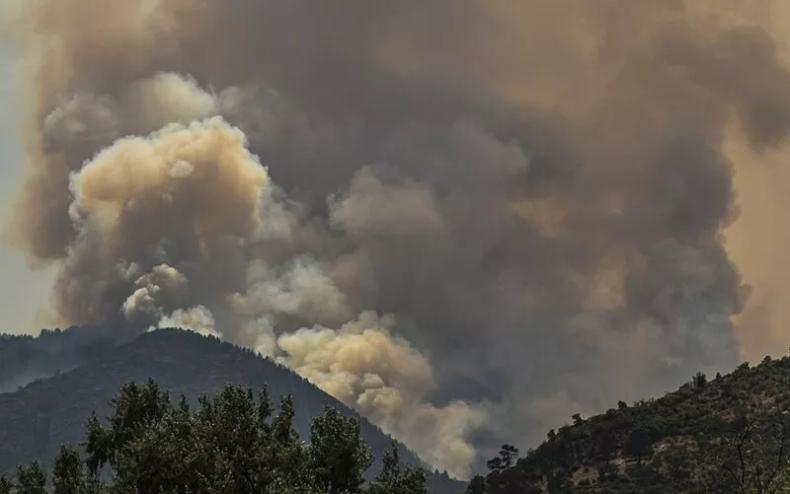 fire and smoke behind mountain
