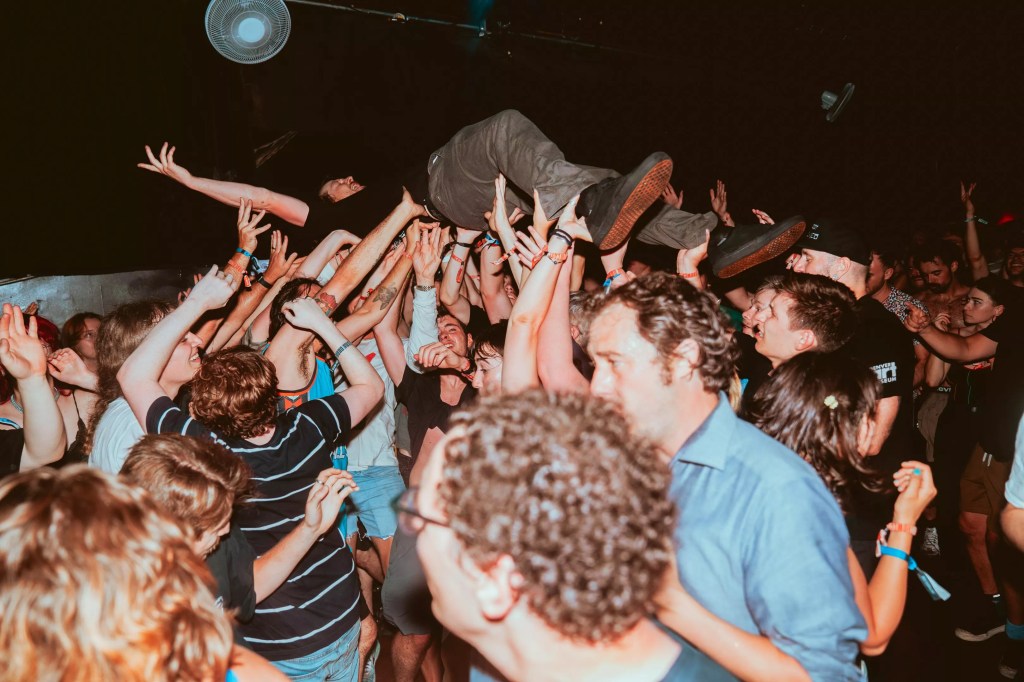 crowd holding up a stage diver