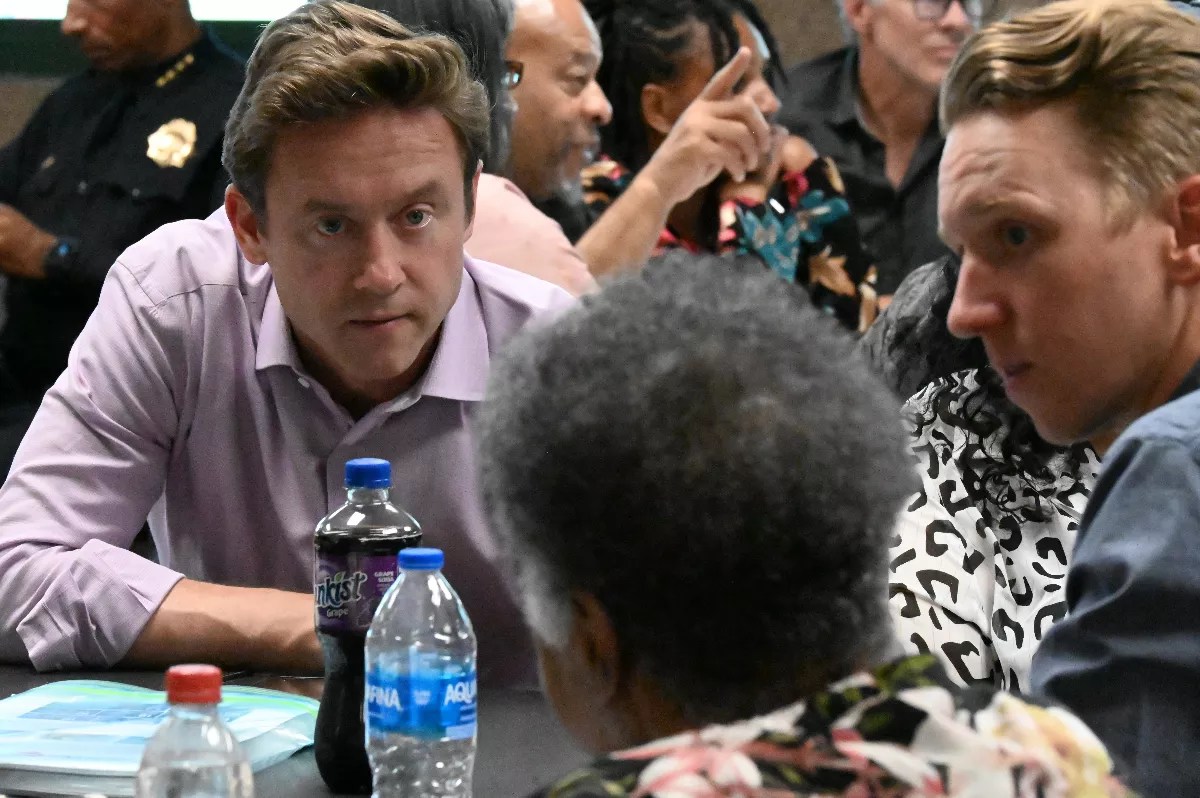 Men have a conversation during town hall