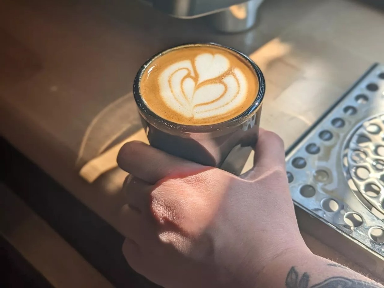 hand holding a latte