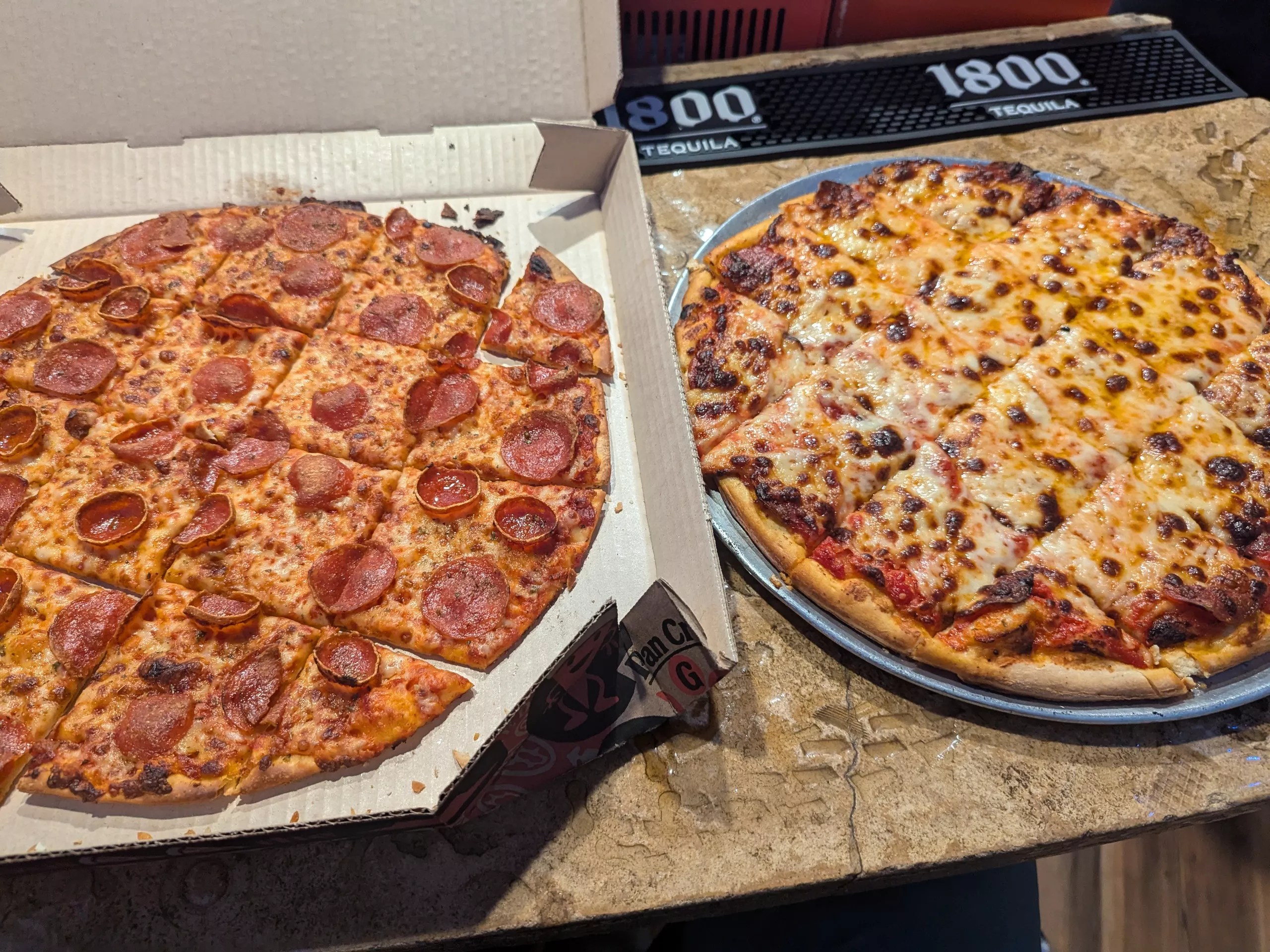 Two pizzas side by side.