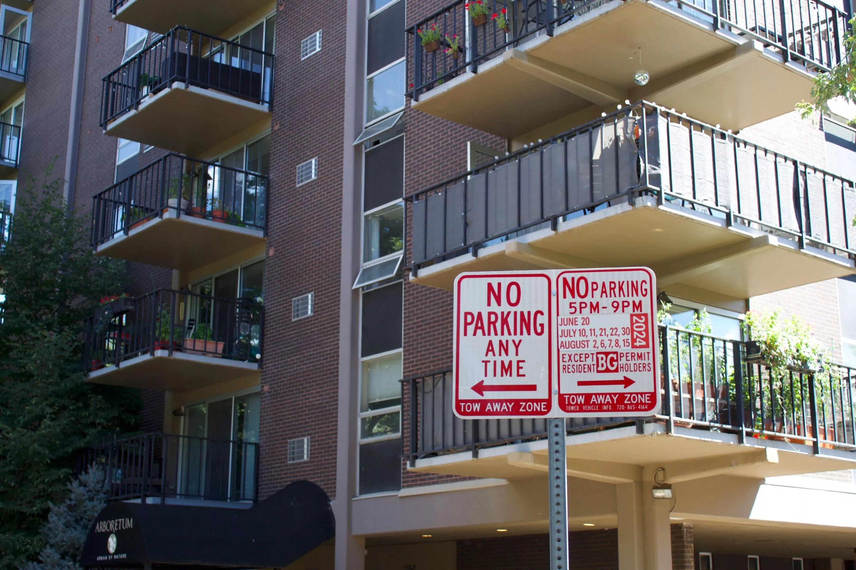 Street parking signs in front of condo