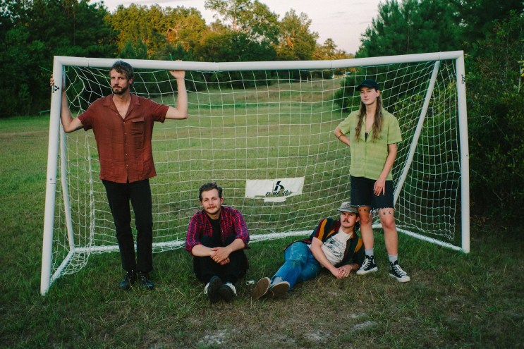 Four musicians in front of net.
