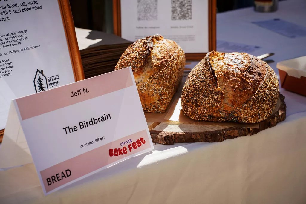 Two loaves of bread next to a sign reading "The Birdbrain,"