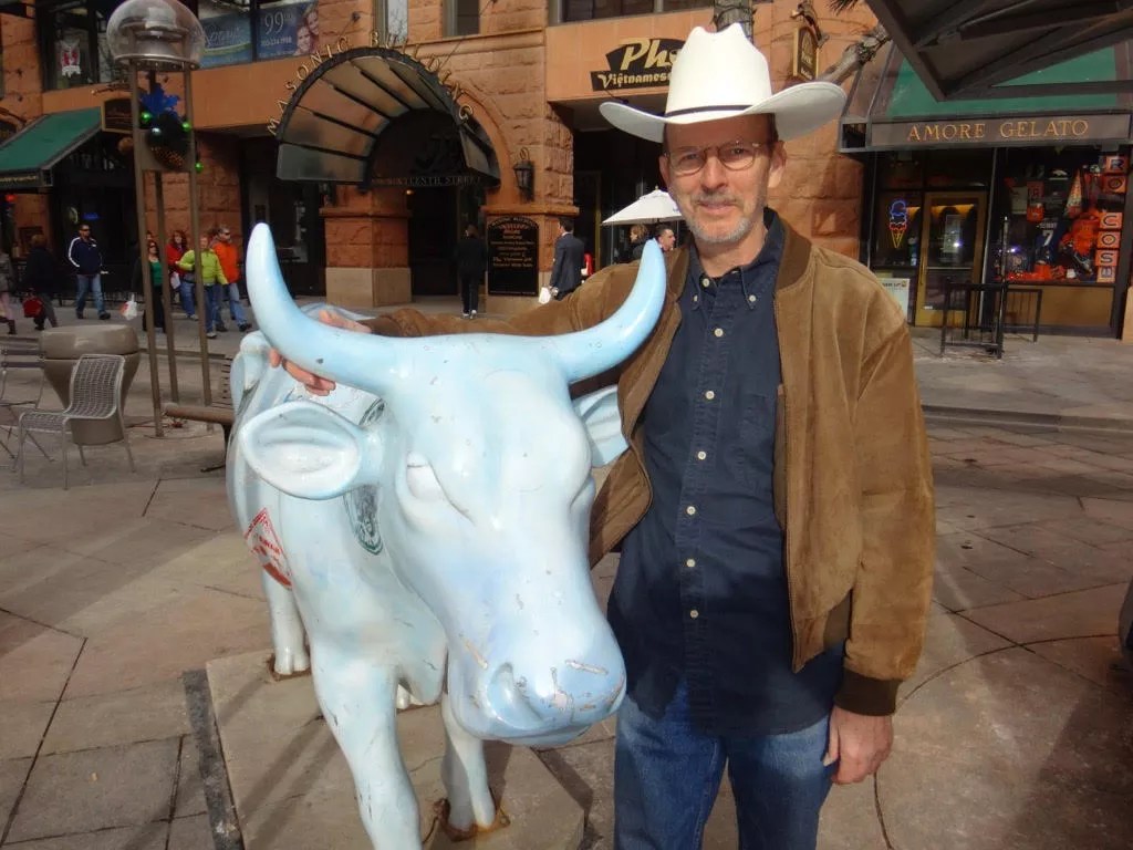 man with cow sculpture