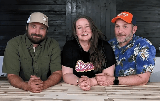 three people sitting and posing for a photo