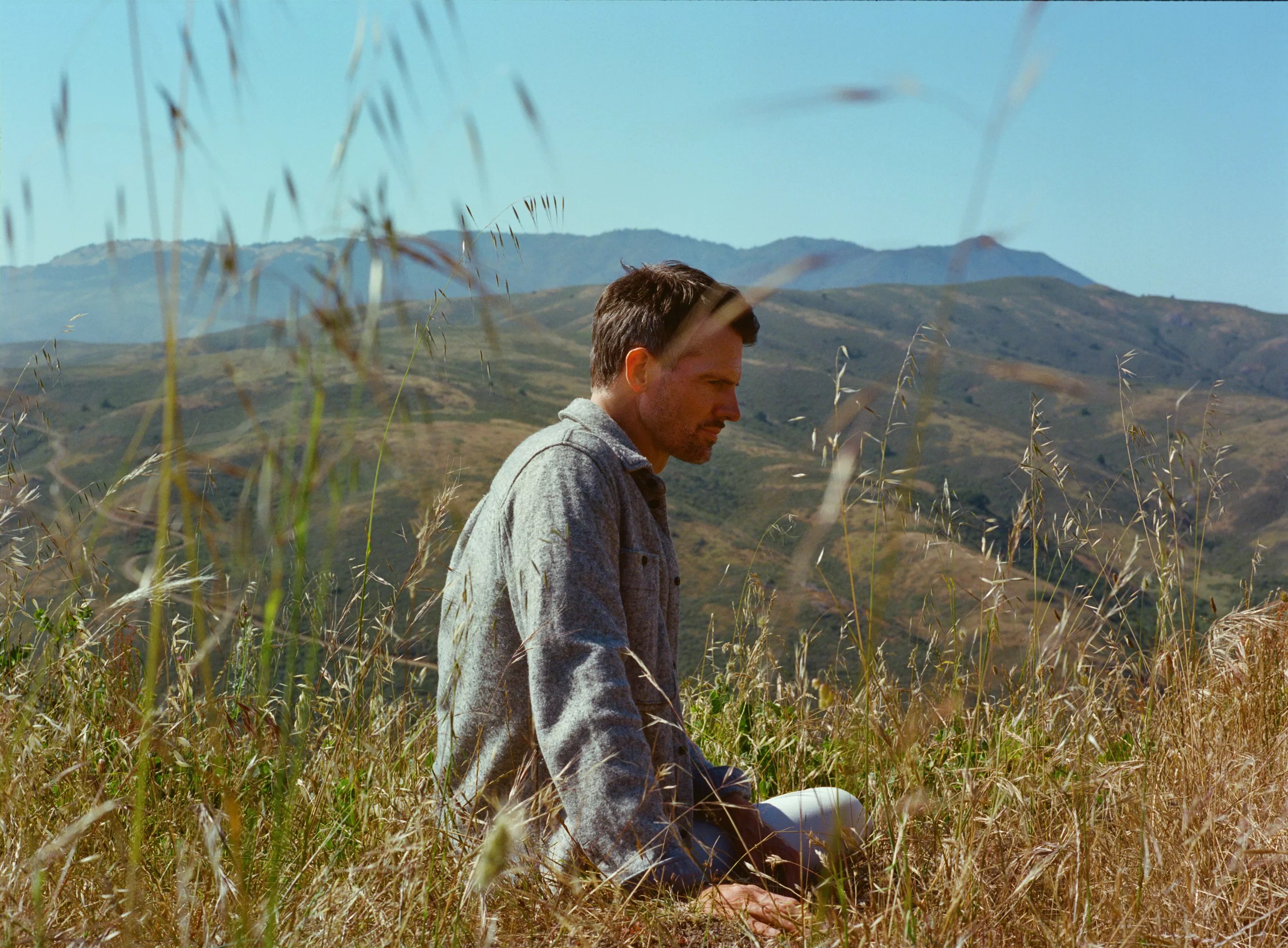 man sitting in a field