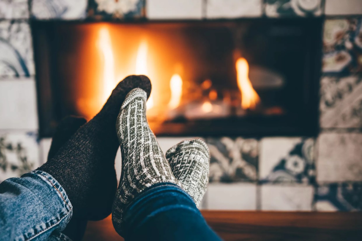 feet in socks in front of fire