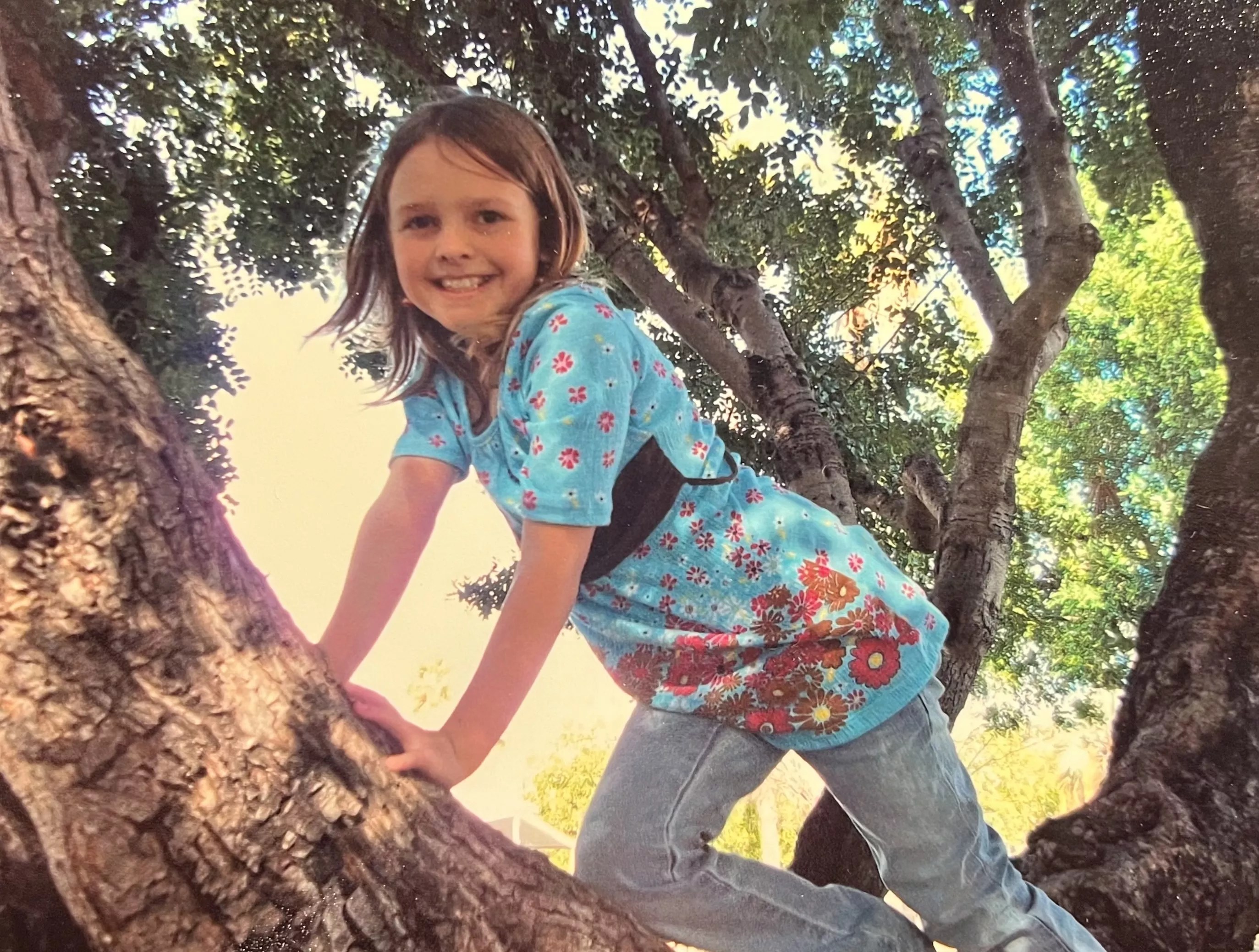 girl climbing tree