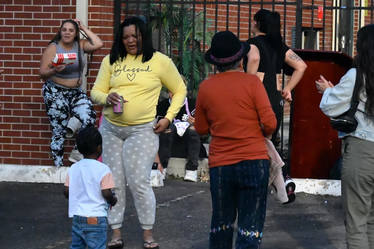 A woman dances with a kid.