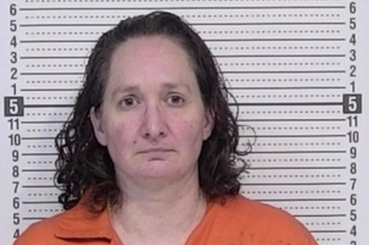 A woman frowns in her mugshot.