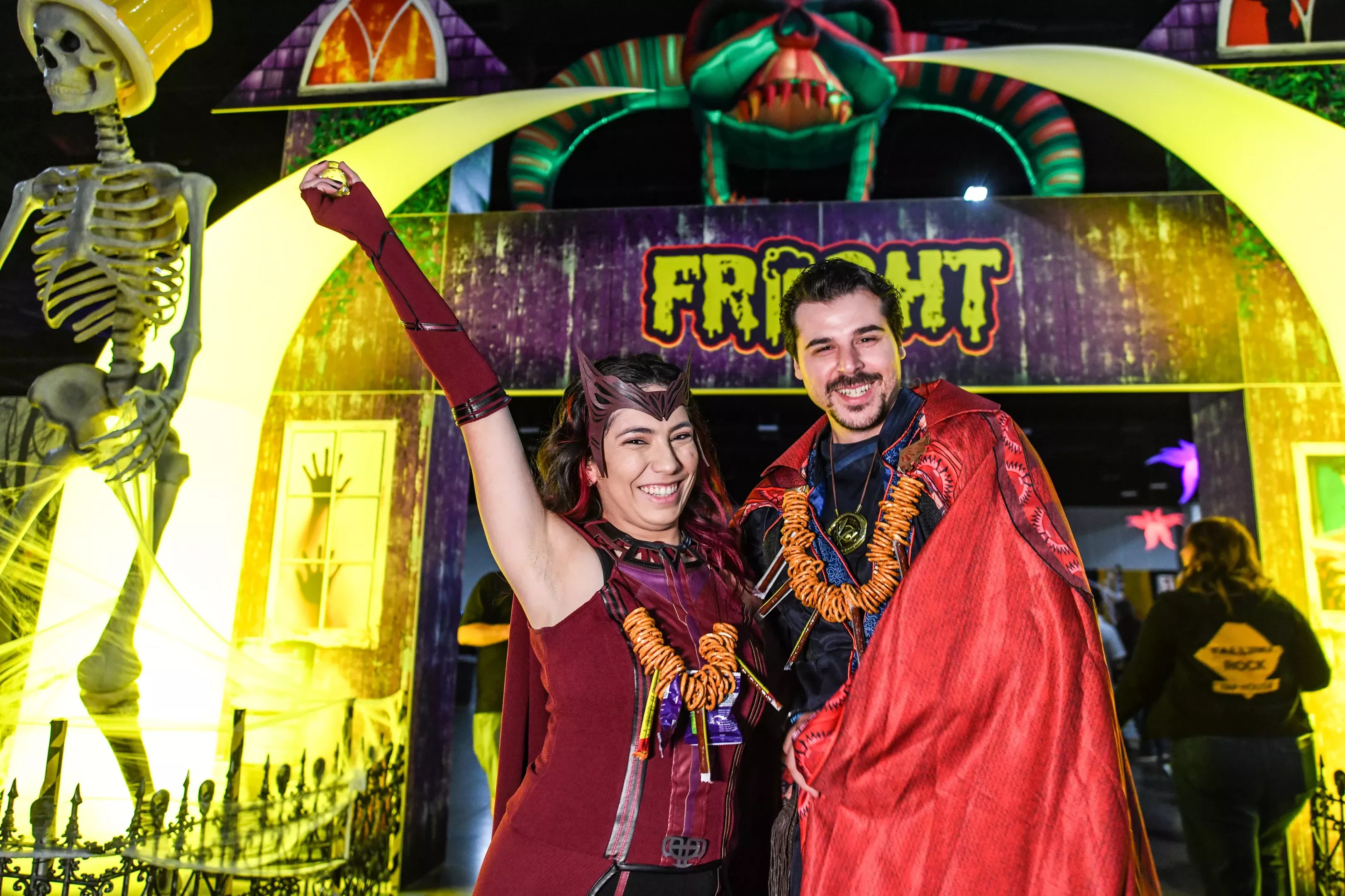 two people wearing costumes and pretzel necklaces