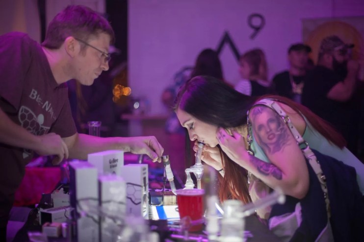 Woman takes weed dab