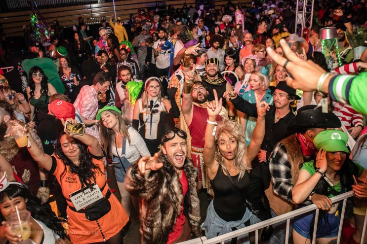 Halloween rave crowd dancing and smiling