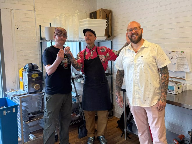three menu posing in a kitchen