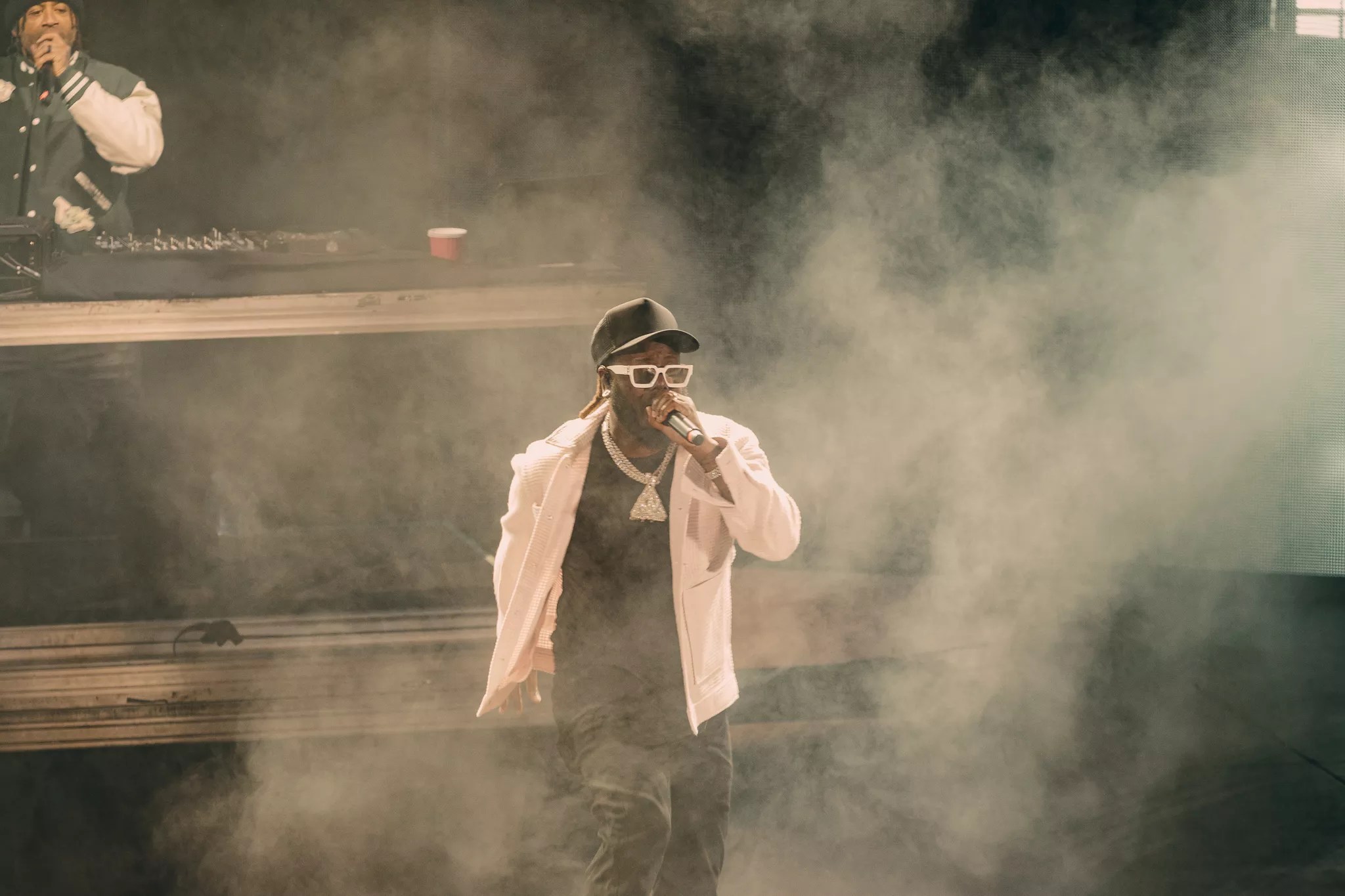 A photo of T-Pain on stage performing at Red Rocks in Morrison, Colorado.