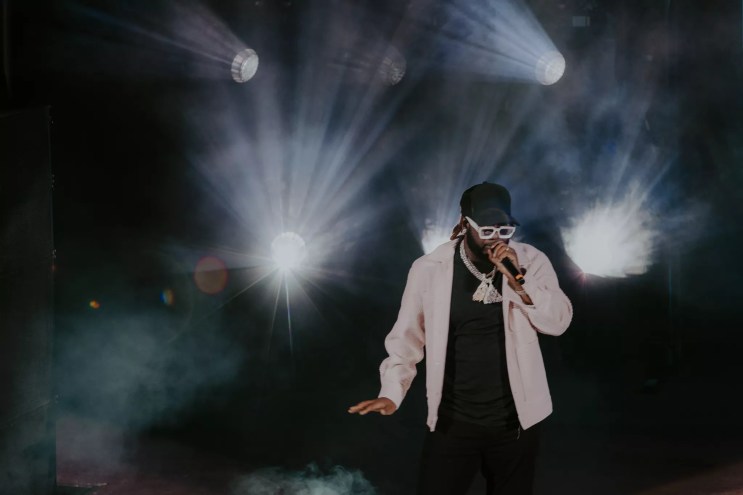 A photo of T-Pain on stage performing at Red Rocks in Morrison, Colorado.