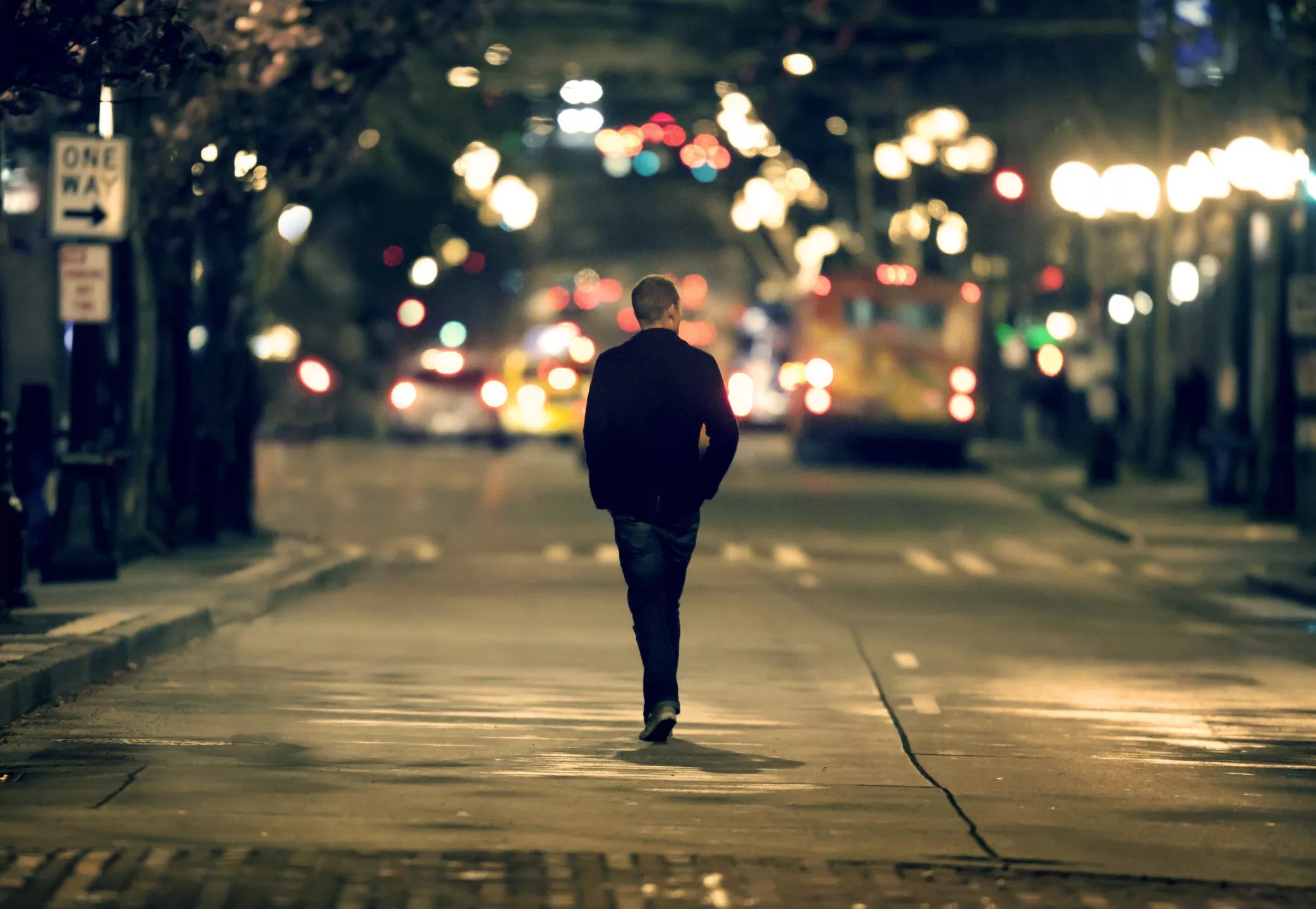 single man walking to lights.