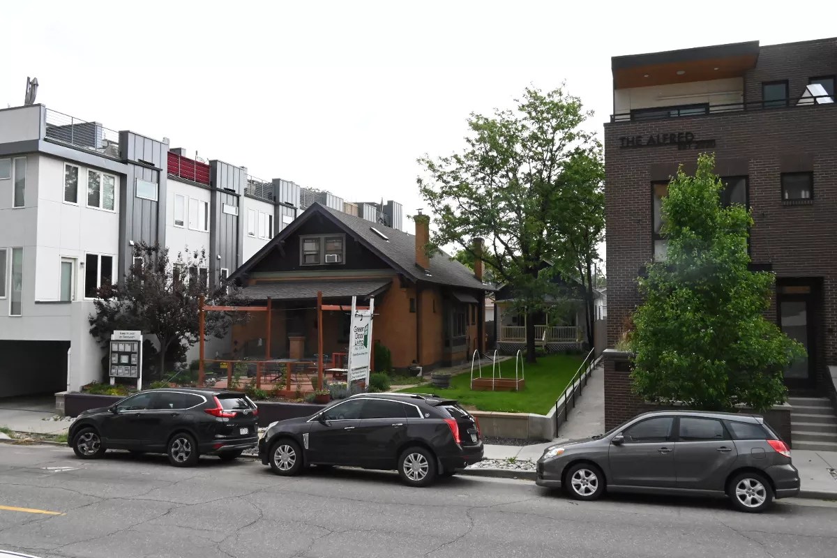 A house is between tall apartments.