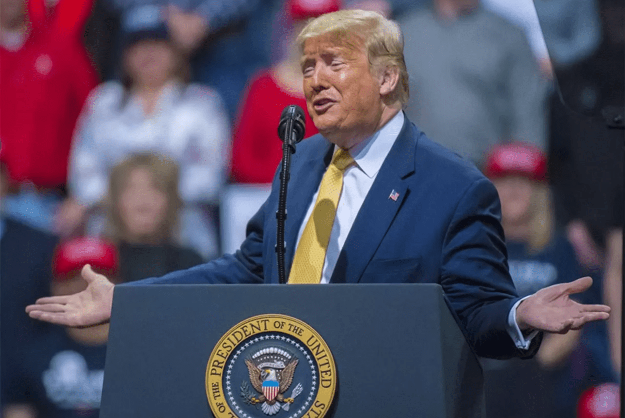 donald trump at podium during rally