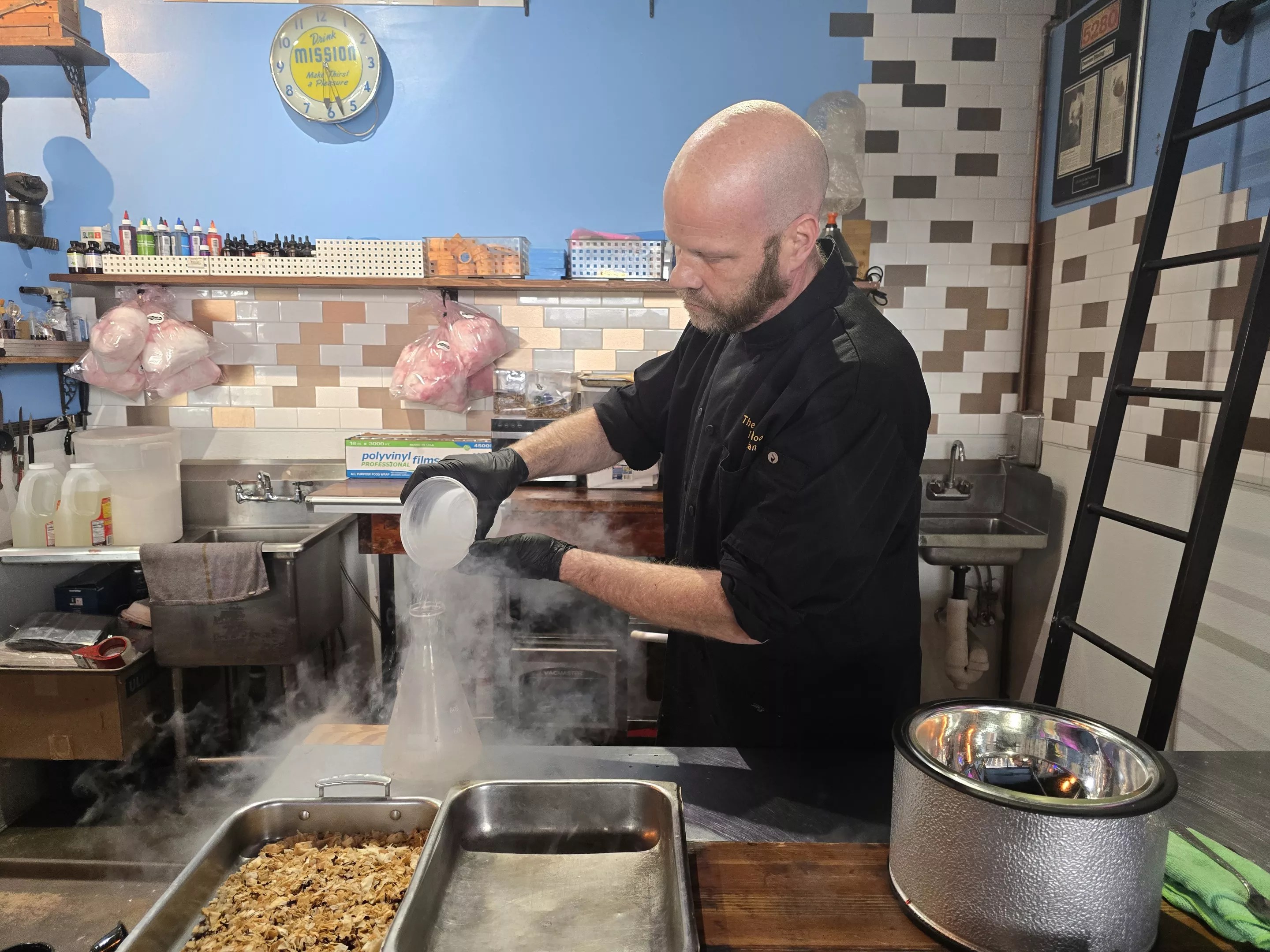 man pouring liquid nitrogen into a bottle