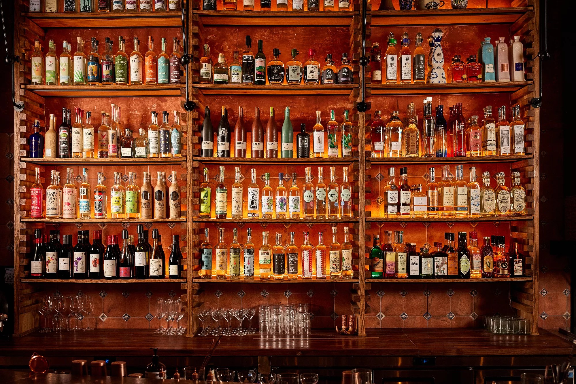 shelves lined with bottles of mezcal
