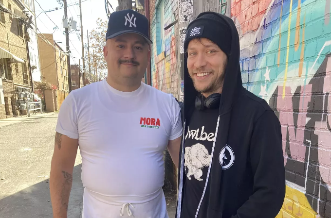 two men standing in an alley