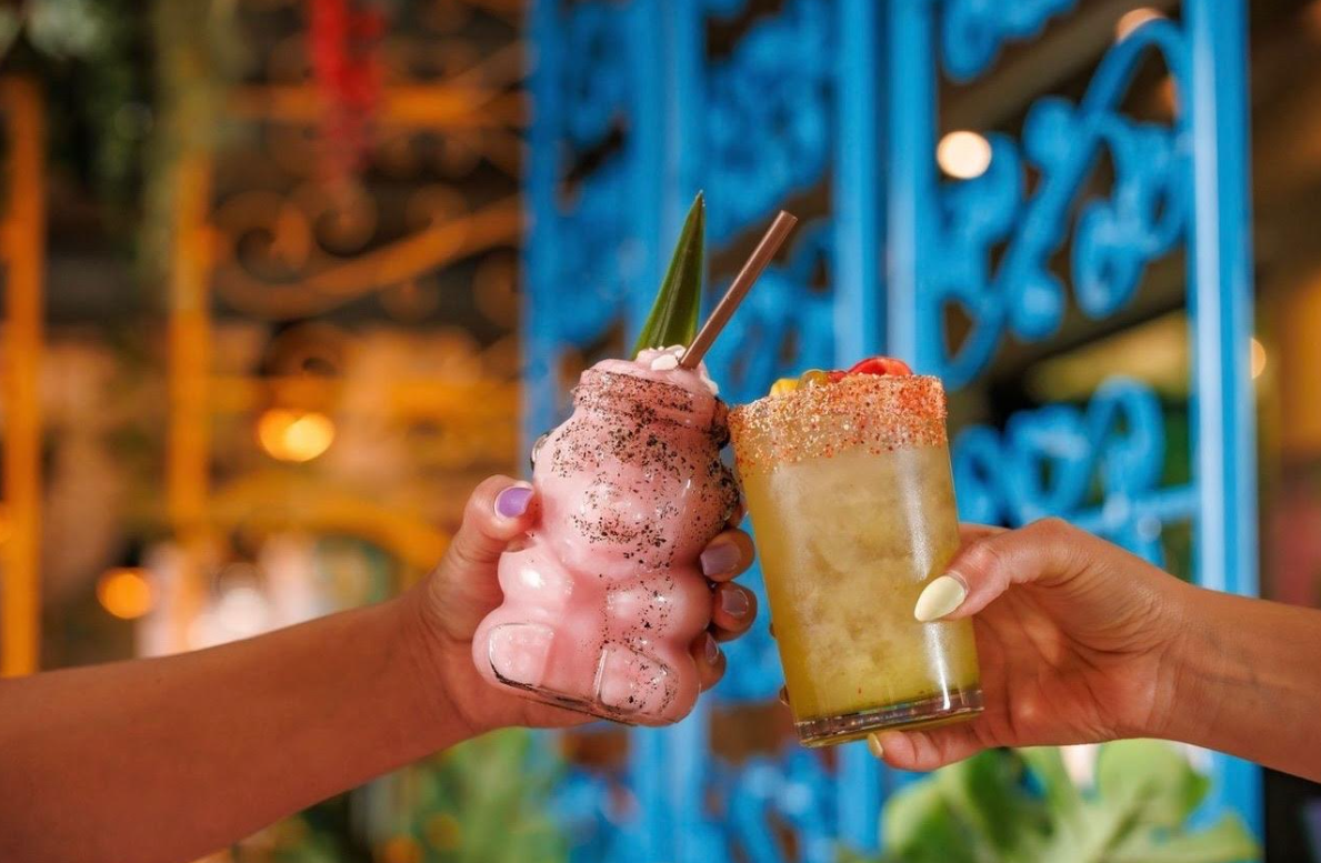 hands holding a frozen drink anda margarita