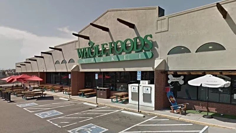 The green and beige exterior of Whole Foods Market in Denver