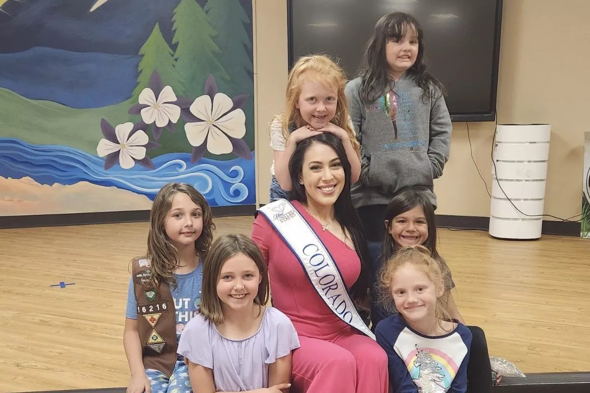 A woman poses with children