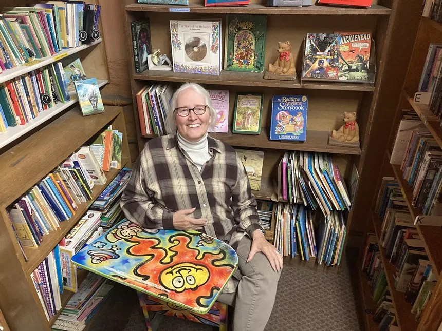 woman with white hair in bookstore