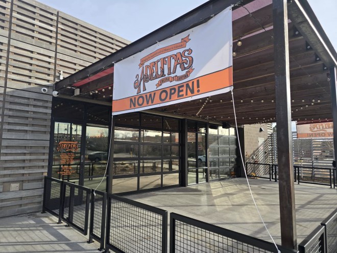 "now open" sign on a building