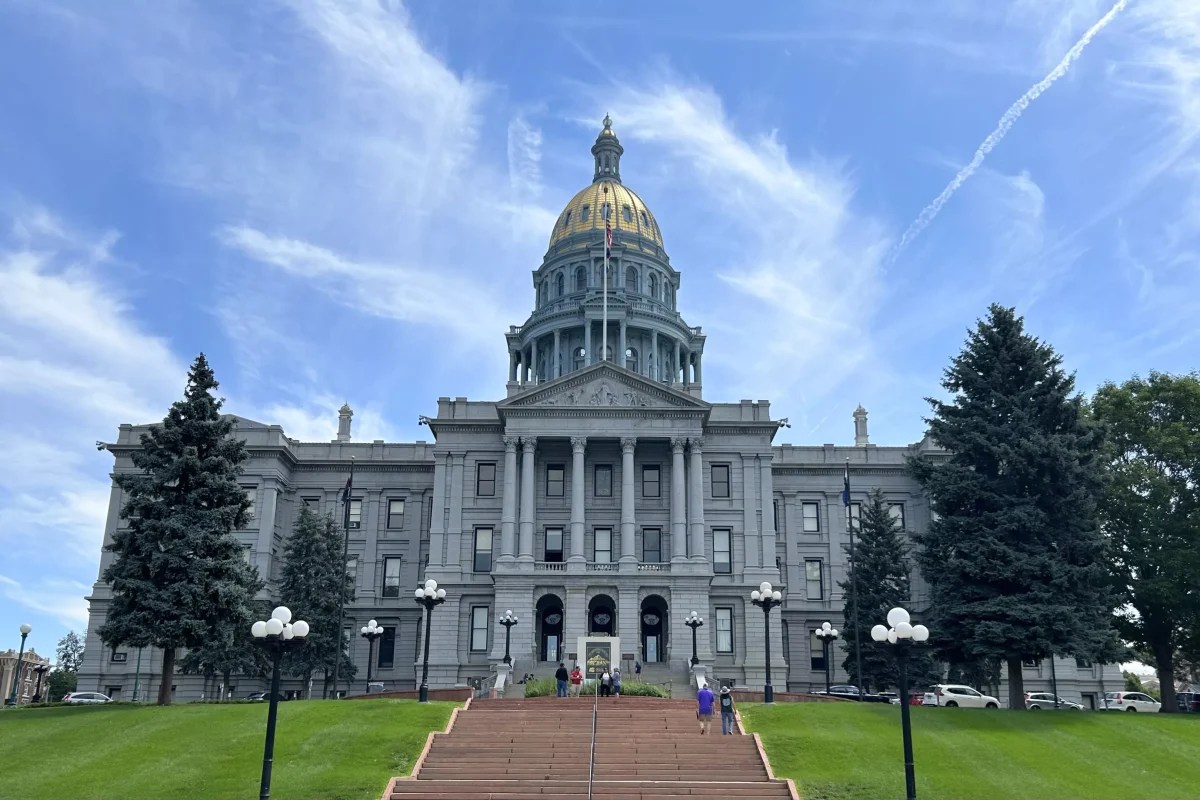 The Colorado State Capitol exterior featuring stone columns and a golden central dome