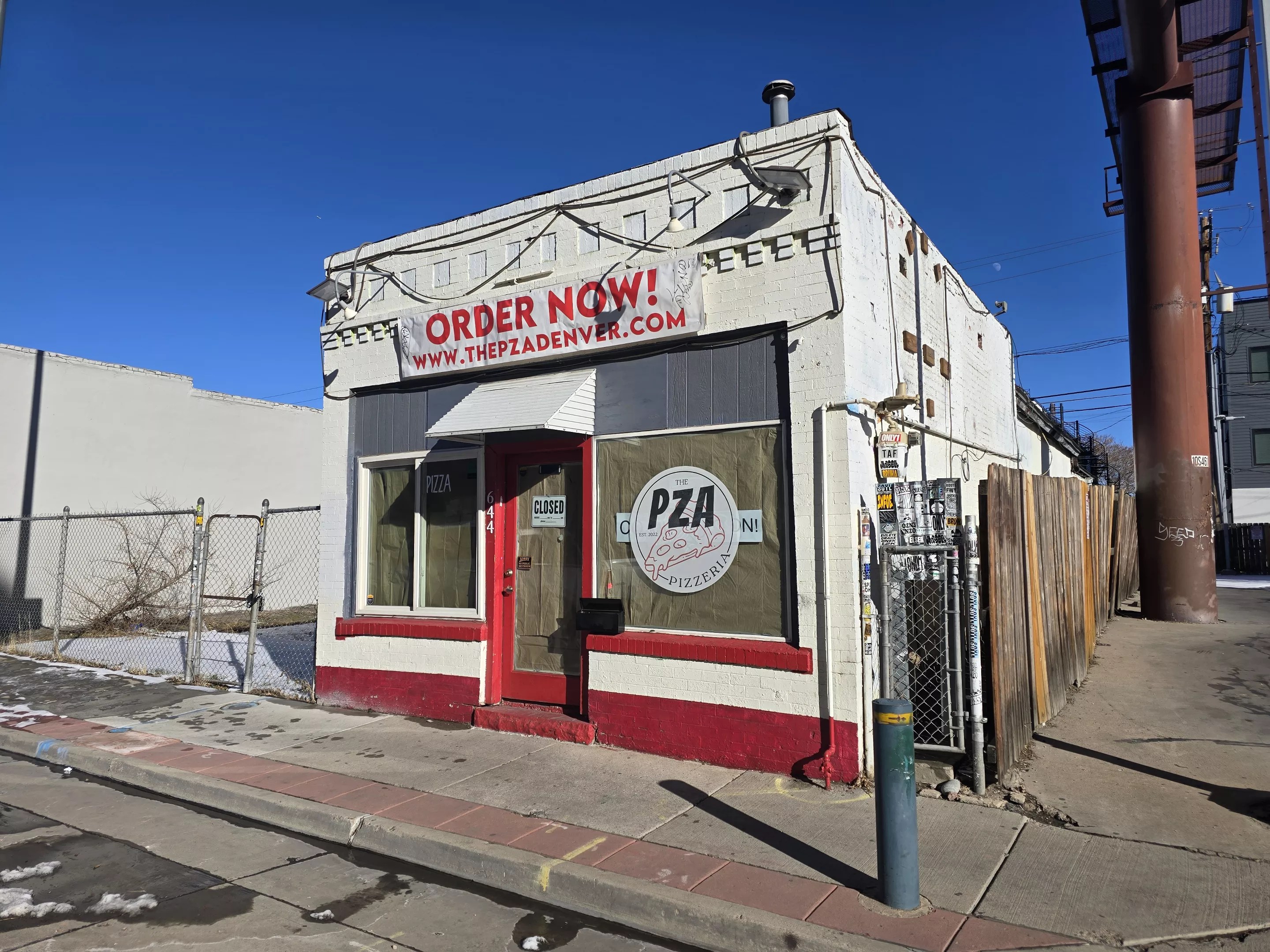 exterior of a small white and red building