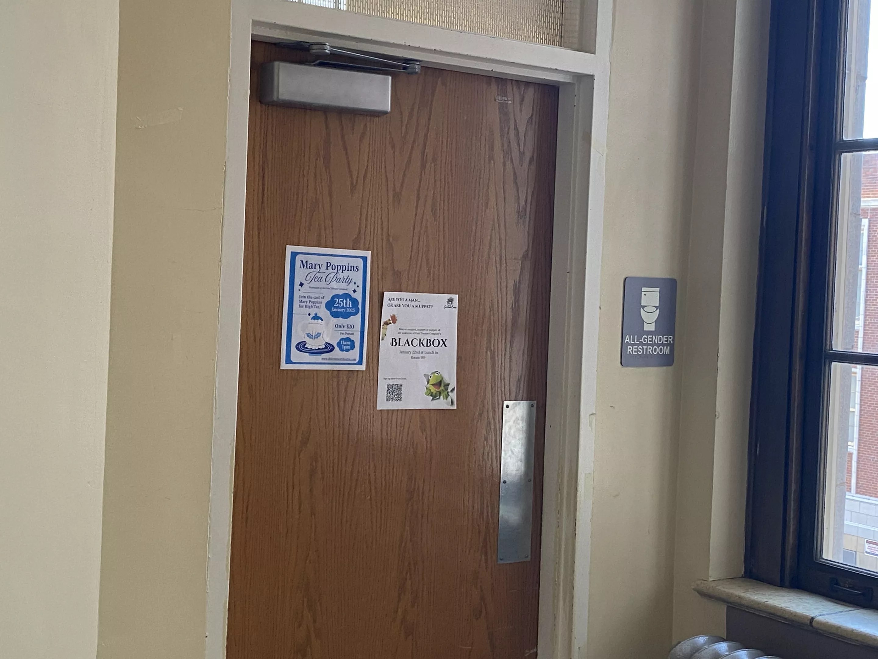 all-gender bathroom door at high school
